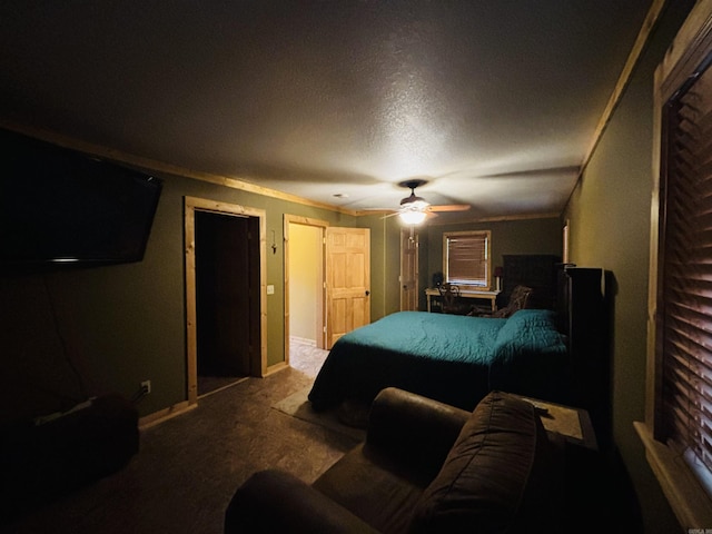 carpeted bedroom featuring baseboards, a ceiling fan, a textured ceiling, and crown molding