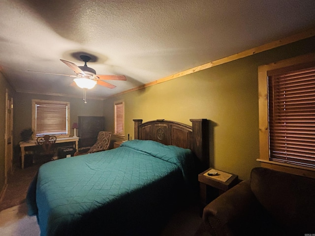 carpeted bedroom with a ceiling fan and a textured ceiling