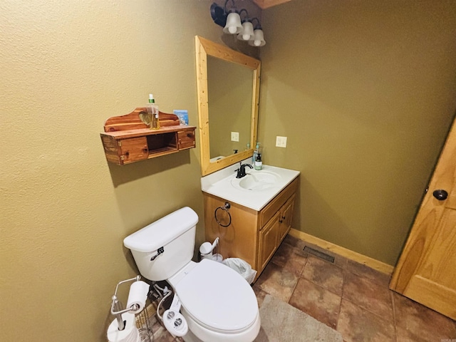 bathroom with visible vents, baseboards, toilet, and vanity