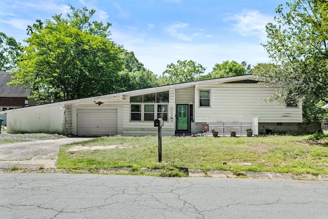 view of front facade with an attached garage, fence, a front lawn, and aphalt driveway