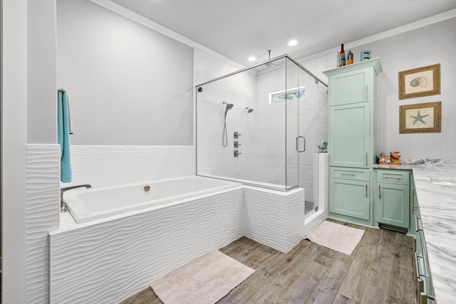 full bathroom with a garden tub, crown molding, wood finished floors, recessed lighting, and a stall shower