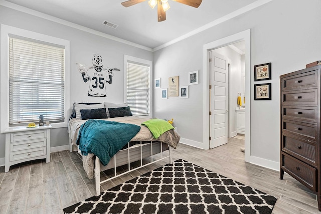 bedroom featuring visible vents, crown molding, baseboards, a ceiling fan, and light wood finished floors