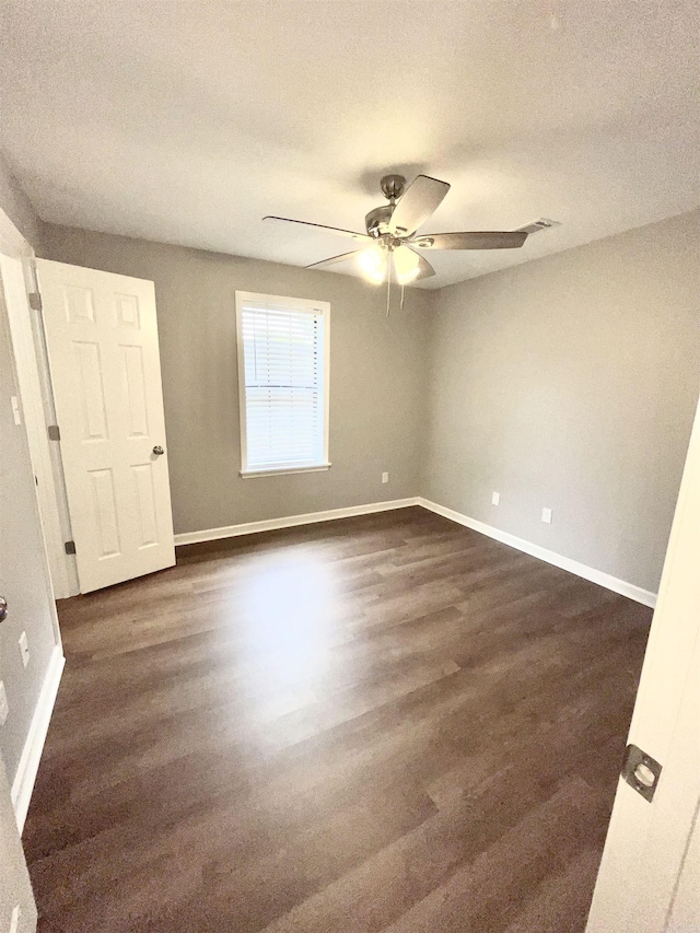 104 Louis, Searcy, AR 72143 - unfurnished bedroom with baseboards, a textured ceiling, ceiling fan, and dark wood-style floors