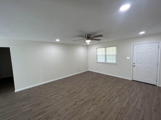 unfurnished living room with baseboards, a ceiling fan, dark wood-style flooring, and recessed lighting