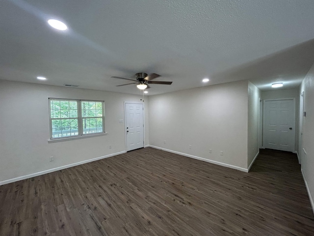unfurnished room with ceiling fan, visible vents, baseboards, dark wood-style floors, and recessed lighting