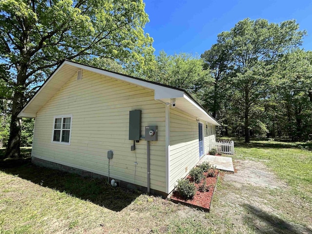 view of property exterior featuring a lawn and crawl space