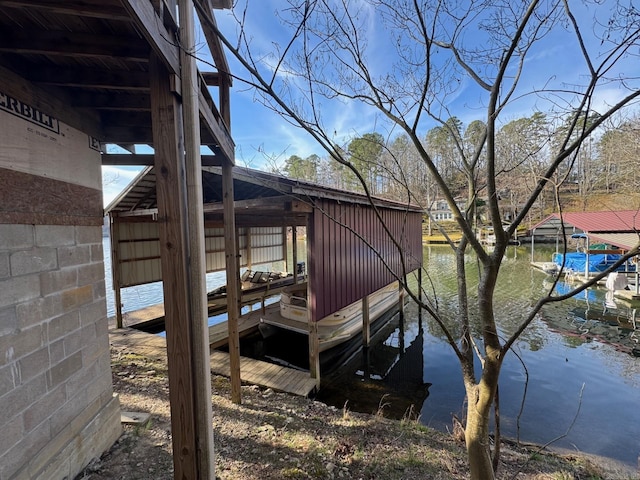 dock area with boat lift and a water view