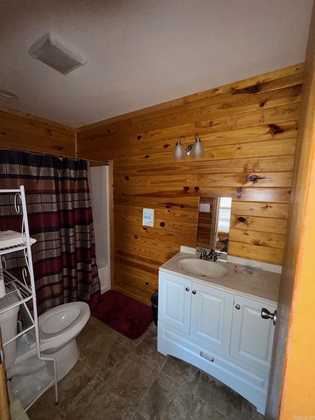 bathroom with visible vents, wood walls, a shower with shower curtain, and vanity