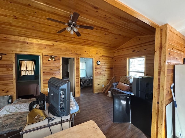 living area featuring wood ceiling, ceiling fan, vaulted ceiling, wood walls, and wood finished floors