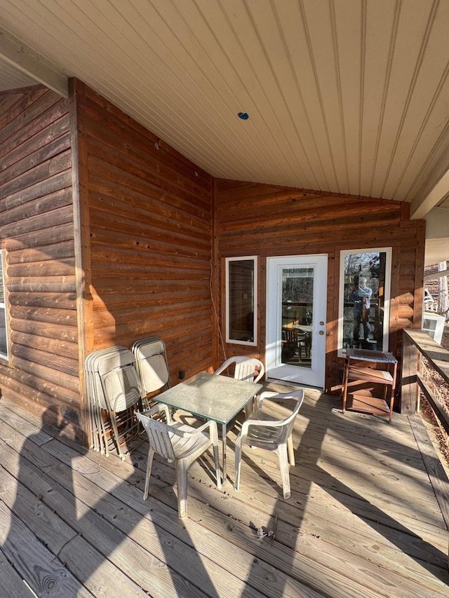 wooden terrace with outdoor dining space