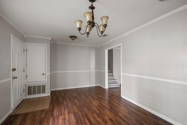 empty room with visible vents, crown molding, wood finished floors, and an inviting chandelier