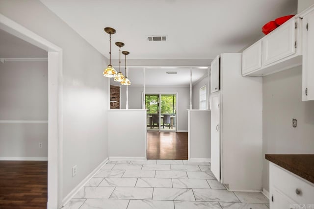 interior space with baseboards, visible vents, and marble finish floor