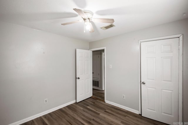 unfurnished bedroom with visible vents, baseboards, ceiling fan, and wood finished floors