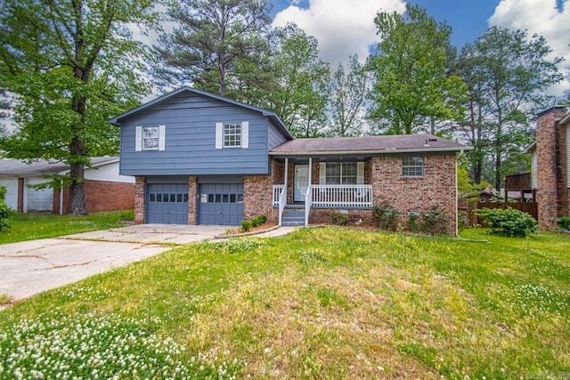 split level home with a porch, brick siding, a front lawn, concrete driveway, and an attached garage