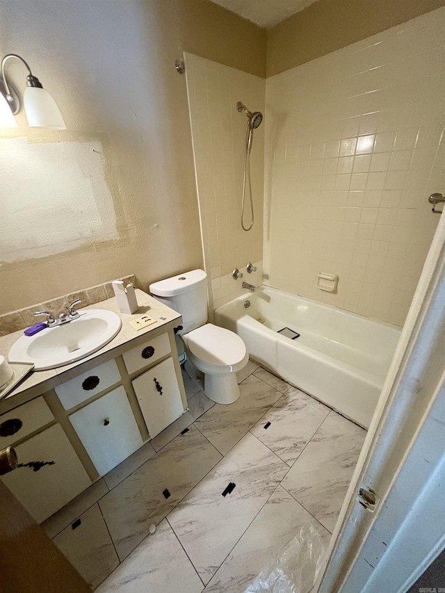 bathroom featuring vanity, marble finish floor, tub / shower combination, and toilet
