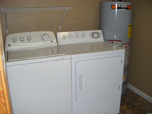 1526 Pine Manor Dr, Arkadelphia, AR 71923 - laundry area with water heater, baseboards, and washer and clothes dryer