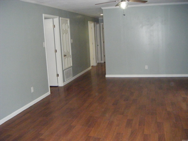 1526 Pine Manor Dr, Arkadelphia, AR 71923 - spare room with baseboards, ornamental molding, a ceiling fan, and dark wood-type flooring