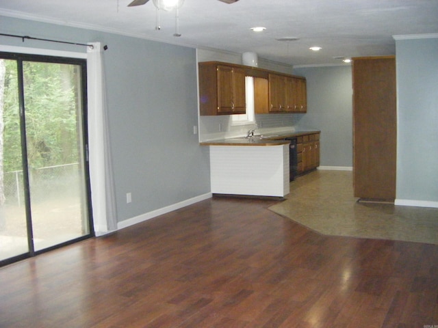 1526 Pine Manor Dr, Arkadelphia, AR 71923 - kitchen featuring a ceiling fan, crown molding, brown cabinets, baseboards, and dark wood-type flooring
