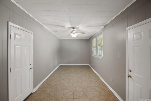 spare room featuring crown molding, ceiling fan, and baseboards
