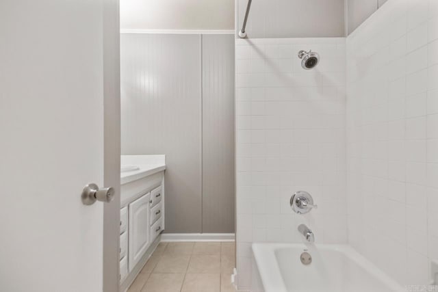 bathroom with baseboards,  shower combination, tile patterned floors, and vanity