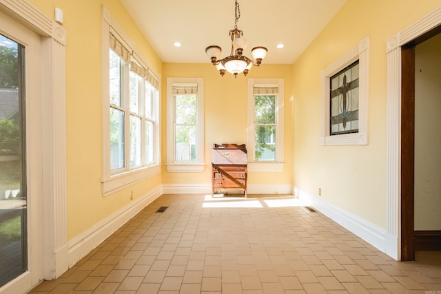 unfurnished dining area featuring baseboards, recessed lighting, tile patterned floors, and a chandelier