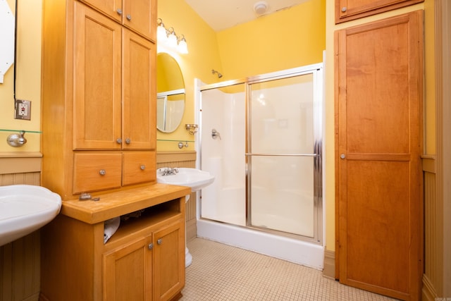 full bath with tile patterned floors and a shower stall