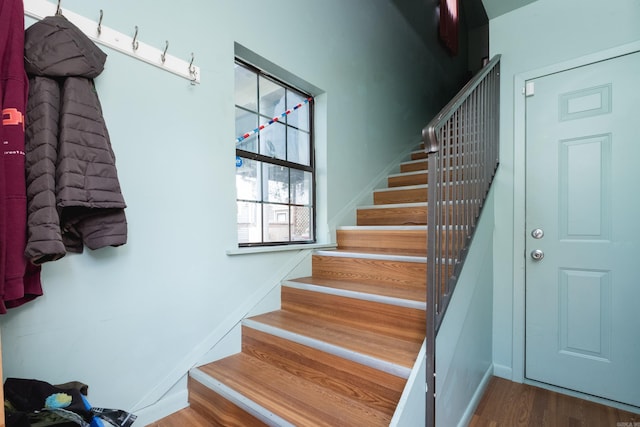 stairs featuring wood finished floors