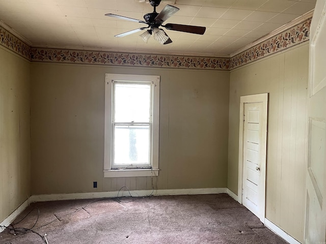 carpeted empty room with crown molding and ceiling fan