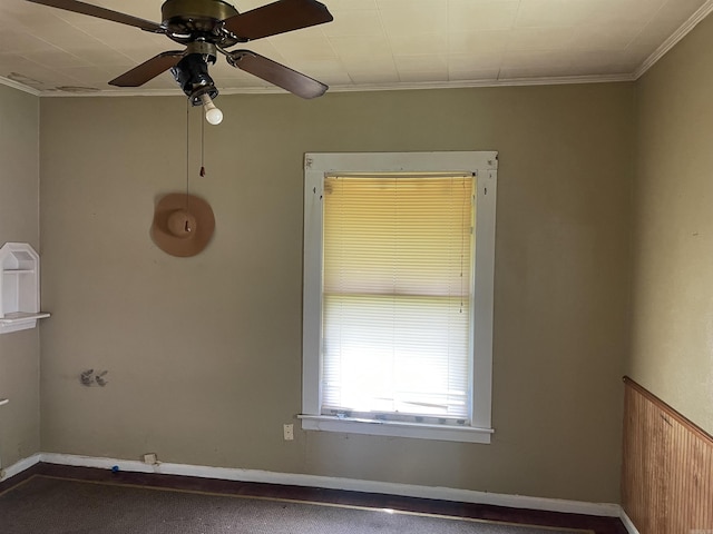 spare room with crown molding and ceiling fan