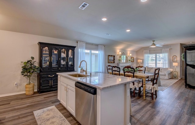 kitchen featuring a kitchen island with sink, visible vents, stainless steel dishwasher, dark wood finished floors, and a sink