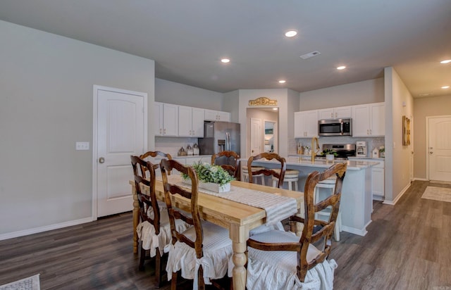 dining area with recessed lighting, baseboards, visible vents, and dark wood-type flooring