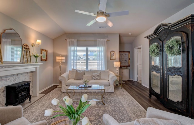 living area featuring a ceiling fan, baseboards, wood finished floors, and lofted ceiling