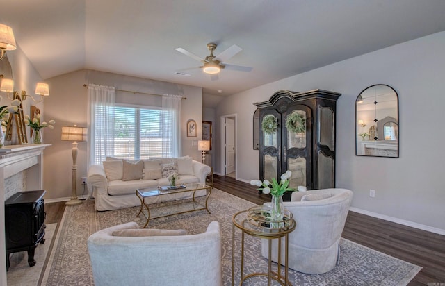 living room with baseboards, a ceiling fan, lofted ceiling, and wood finished floors