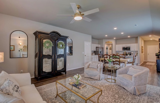 living room featuring a ceiling fan, baseboards, recessed lighting, and wood finished floors
