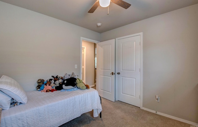bedroom with baseboards, light colored carpet, and ceiling fan