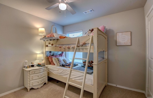 carpeted bedroom featuring a ceiling fan, baseboards, and visible vents