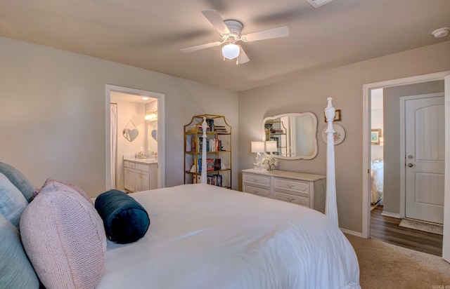 carpeted bedroom with baseboards, ceiling fan, and ensuite bath