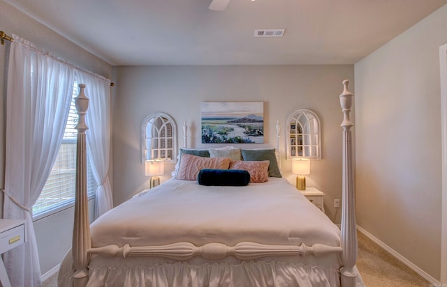 bedroom featuring carpet floors, baseboards, visible vents, and ceiling fan