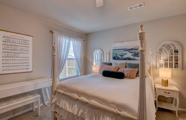 carpeted bedroom featuring visible vents, baseboards, and ceiling fan
