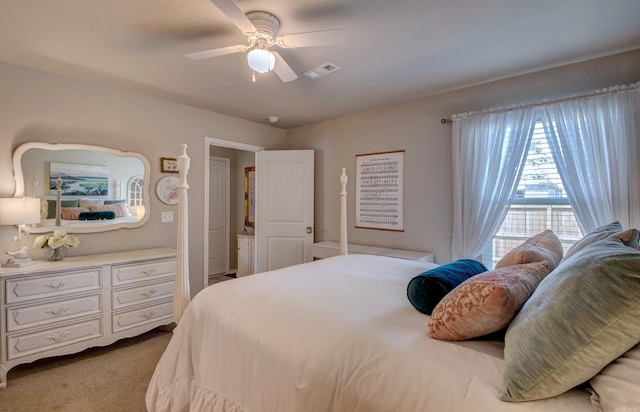 carpeted bedroom featuring visible vents and ceiling fan