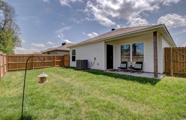back of property featuring a fenced backyard, a lawn, and cooling unit