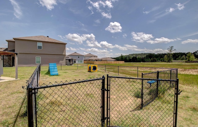 view of yard featuring fence and a gate