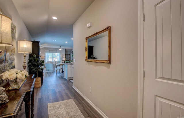 hall with dark wood-style flooring, baseboards, recessed lighting, and lofted ceiling