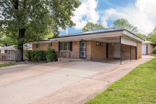 ranch-style house featuring concrete driveway, brick siding, and an attached carport
