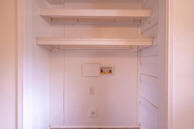 clothes washing area with washer hookup, hookup for an electric dryer, and laundry area