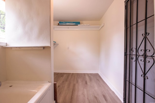 interior space featuring baseboards and light wood-style flooring