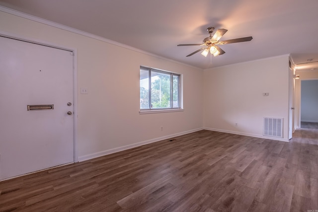 interior space with ornamental molding, wood finished floors, and visible vents