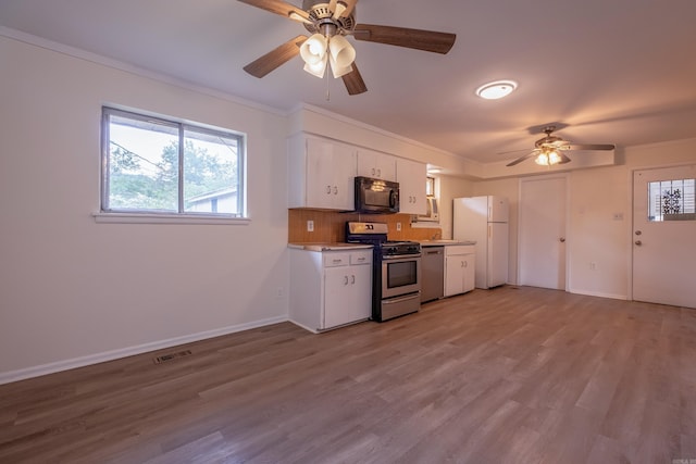 kitchen featuring freestanding refrigerator, black microwave, ceiling fan, dishwasher, and gas stove