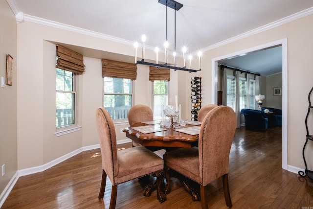 dining area featuring crown molding, a chandelier, a wealth of natural light, and dark wood-type flooring