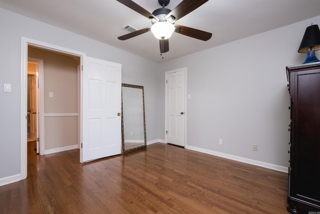 unfurnished bedroom featuring ceiling fan, baseboards, visible vents, and wood finished floors
